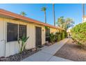 Light-beige building exterior with walkway, landscaping, and palm trees at 8241 N Central Ave # 11, Phoenix, AZ 85020