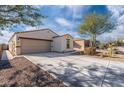Single story home with driveway and desert landscaping at 12657 W Myrtle Ave, Glendale, AZ 85307
