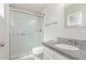 Updated bathroom with glass-enclosed shower and granite vanity at 14846 N 29Th Ave, Phoenix, AZ 85053