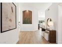 Spacious hallway with unique wall decor and wood-look flooring at 16442 N 58Th St, Scottsdale, AZ 85254