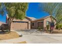 Spacious house featuring a three car garage, desert landscaping, and a well-maintained yard at 21754 E Caldwells Ct, Queen Creek, AZ 85142