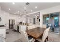 Open-concept kitchen featuring stainless steel appliances, granite countertops, and a view into the living room at 21754 E Caldwells Ct, Queen Creek, AZ 85142