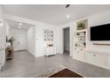 Bright living room features neutral walls, tile flooring, and stylish white built-in shelving at 21754 E Caldwells Ct, Queen Creek, AZ 85142