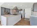 Bright kitchen with gray cabinets, stainless steel appliances, and a large island with white marble countertops at 2323 N Central Ave # 502, Phoenix, AZ 85004