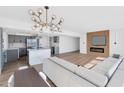 Open living space featuring modern lighting, a fireplace, a large couch, and an open kitchen concept at 2323 N Central Ave # 502, Phoenix, AZ 85004