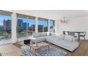 Light-filled living room boasts city views, a comfortable couch, and stylish furnishings, offering urban comfort at 2323 N Central Ave # 502, Phoenix, AZ 85004