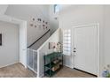 Bright entryway with staircase, storage, and console table at 2403 W Via Dona Rd, Phoenix, AZ 85085