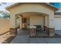 Front porch with stone accents and a small bench at 2403 W Via Dona Rd, Phoenix, AZ 85085