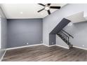 Living room with gray walls, wood-look floors, and staircase at 2544 W Campbell Ave # 41, Phoenix, AZ 85017