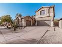 Two-story house with a three-car garage and desert landscaping at 3054 W Eagle Claw Dr, Phoenix, AZ 85086