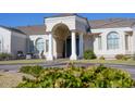 Inviting front entrance with columns, archway, and neatly landscaped grounds at 3528 E Decatur St, Mesa, AZ 85213