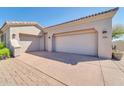 Three-car garage with paver driveway at 37181 N 103Rd St, Scottsdale, AZ 85262