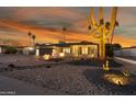 Stunning curb appeal with desert landscaping, lighting, and a large saguaro cactus at 4942 E Wethersfield Rd, Scottsdale, AZ 85254