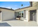 Front porch with tile flooring and a wicker bench, offering a welcoming entrance at 4942 E Wethersfield Rd, Scottsdale, AZ 85254