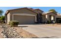 House exterior with a two-car garage and rock landscaping at 5126 S Sugarberry Ct, Gilbert, AZ 85298