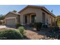 One story house with a covered patio and desert landscaping at 5126 S Sugarberry Ct, Gilbert, AZ 85298