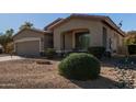 Tan house with a two-car garage and mature shrubbery at 5126 S Sugarberry Ct, Gilbert, AZ 85298