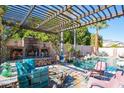 Relaxing pool area with a pergola and fireplace at 758 S Lagoon Dr, Gilbert, AZ 85233