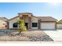 Single-story home with stone accents and a two-car garage at 9715 W Escuda Dr, Peoria, AZ 85382