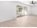 Spacious living room with light flooring and sliding glass doors leading to a patio at 10127 W Forrester Dr, Sun City, AZ 85351