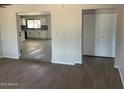 Open living room with wood-look tile floors and a view into the kitchen at 10220 N 36Th N Ave, Phoenix, AZ 85051