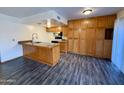 Kitchen boasts wood cabinets and flooring at 1051 N 84Th Pl, Scottsdale, AZ 85257