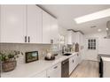 Sleek kitchen with white shaker cabinets, hexagon tile backsplash, and stainless steel appliances at 126 E Northern Ave, Phoenix, AZ 85020
