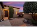 Brick paved courtyard with seating area and desert landscaping at 13036 W Fetlock Trl, Peoria, AZ 85383