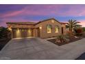 Two-car garage and desert landscaping; inviting curb appeal at 13036 W Fetlock Trl, Peoria, AZ 85383
