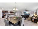 Bright dining area with a large table and access to the kitchen at 1436 N Claiborne --, Mesa, AZ 85205