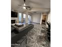Open living room featuring wood-look tile flooring, a fireplace, and access to the balcony at 200 E Southern Ave # 242, Tempe, AZ 85282