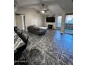 Bright living room featuring wood-look tile flooring, fireplace, and exterior balcony at 200 E Southern Ave # 242, Tempe, AZ 85282