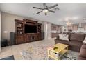 Open living space with a large sectional sofa, entertainment center and kitchen view at 20562 E Raven Dr, Queen Creek, AZ 85142