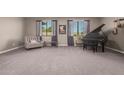 Relaxing living room with gray carpet, comfy chair, and a grand piano at 20562 E Raven Dr, Queen Creek, AZ 85142