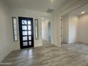 Bright and airy entryway with tile flooring and a modern black front door at 2455 E Presidio St, Mesa, AZ 85213