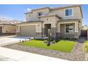 Two story home with landscaped front yard and attached garage at 27165 N 71St Ln, Peoria, AZ 85383