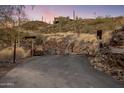 Custom metal entry gate leading to a secluded estate at 37300 N School House Rd, Cave Creek, AZ 85331