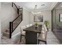 Elegant dining room with modern chandelier and staircase to the second floor at 3855 S Mcqueen Rd # 9, Chandler, AZ 85286