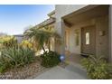 Inviting front porch entrance features stylish landscaping and a neutral colored front door at 4615 W Corral Rd, Laveen, AZ 85339