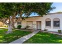 Front view of a light beige stucco house with a walkway and lawn at 5984 N 83Rd St, Scottsdale, AZ 85250