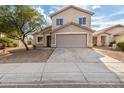 Tan two-story house with a two-car garage and driveway at 6537 W Riva Rd, Phoenix, AZ 85043