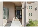 Elegant entryway with a dark wood door and glass block accents at 11850 E Del Timbre Dr, Scottsdale, AZ 85259