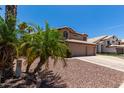 Two-story house with three-car garage and mature palm trees at 1231 N Layman St, Gilbert, AZ 85233