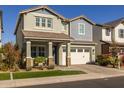 Two-story home with a white garage door and landscaping at 1336 E Sierra Vista Dr, Phoenix, AZ 85014