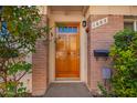 Wood front door entry to a charming condo at 1682 W Campbell Ave, Phoenix, AZ 85015