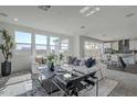 Open-concept living room leads to a dining area and kitchen with lots of natural light at 17219 W Vacaville St, Surprise, AZ 85388