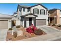 Two-story house with gray exterior, landscaping, and attached garage at 20838 W Granada Rd, Buckeye, AZ 85396