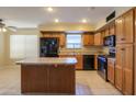 Kitchen with island, stainless steel appliances, and wood cabinets at 21404 N Van Loo Dr, Maricopa, AZ 85138