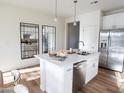 Modern kitchen with white cabinets, island, and stainless steel appliances at 2191 N Iowa St, Chandler, AZ 85225