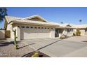 Tan stucco house with a two-car garage and gravel landscaping at 2544 S Daisy --, Mesa, AZ 85209